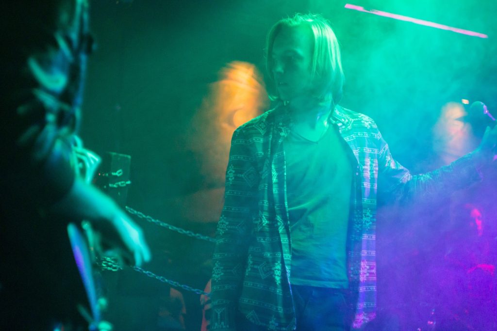 A performer pauses at a grunge rock concert.
