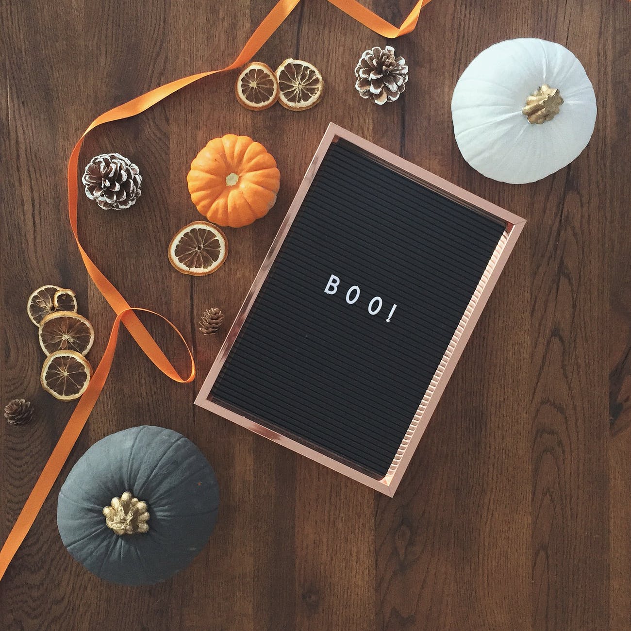 Three gourds sitting near a black box with the word "boo" is evocative of the fall.
