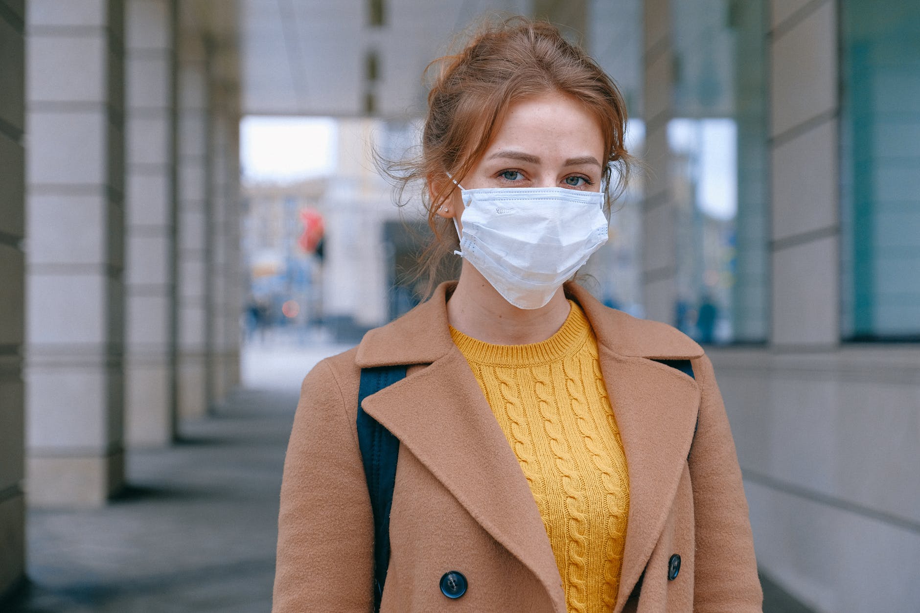 This woman's expression is hard to read because her face mask covers up her mouth and nose.