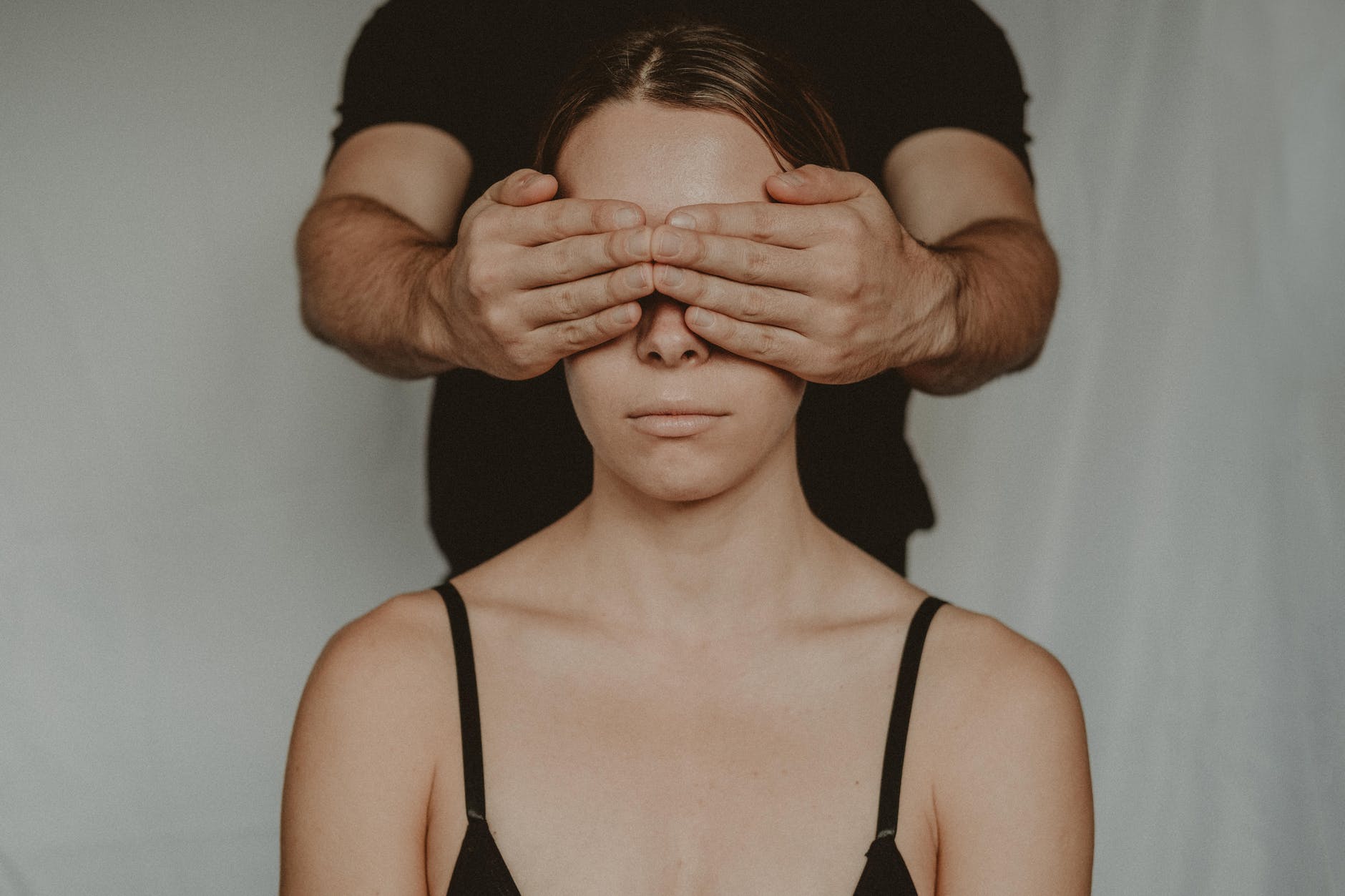A man covers a woman's eyes; it doesn't look abusive, but could it be?